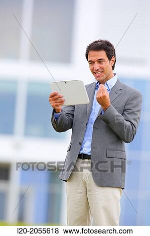 Businessman with tablet in business center. San Sebastian Technology Park. Donostia. Gipuzkoa. Basque Country. Spain. View Large Photo Image Stock Photo - Businessman with tablet in business center. San Sebastian Technology Park. Donostia. Gipuzkoa. Basque Country. Spain.. Fotosearch