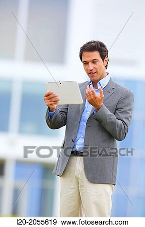 Businessman with tablet in business center. San Sebastian Technology Park. Donostia. Gipuzkoa. Basque Country. Spain. View Large Photo Image Stock Photo - Businessman with tablet in business center. San Sebastian Technology Park. Donostia. Gipuzkoa. Basque Country. Spain.. Fotosearch