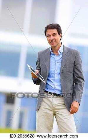 Stock Photo - Businessman with tablet in business center. San Sebastian Technology Park. Donostia. Gipuzkoa. Basque Country. Spain.. Fotosearch