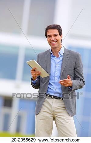 Stock Photo - Businessman with tablet in business center. San Sebastian Technology Park. Donostia. Gipuzkoa. Basque Country. Spain.. Fotosearch