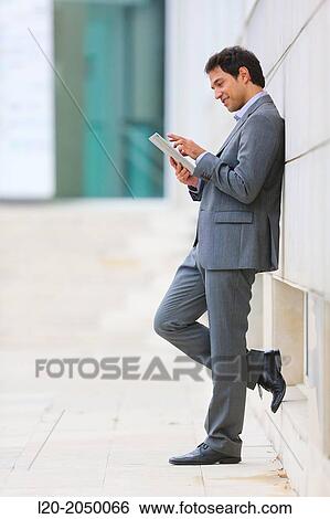 Businessman with tablet in business center. San Sebastian Technology Park. Donostia. Gipuzkoa. Basque Country. Spain. View Large Photo Image Stock Photograph - Businessman with tablet in business center. San Sebastian Technology Park. Donostia. Gipuzkoa. Basque Country. Spain.. Fotosearch