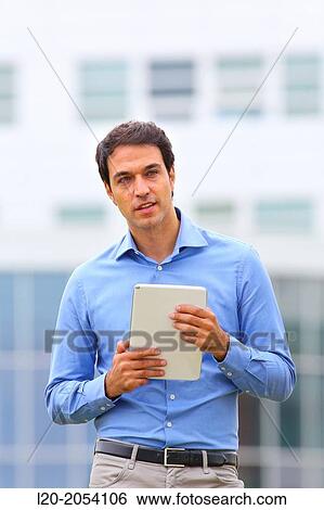 Businessman with tablet in business center. San Sebastian Technology Park. Donostia. Gipuzkoa. Basque Country. Spain. View Large Photo Image Stock Photograph - Businessman with tablet in business center. San Sebastian Technology Park. Donostia. Gipuzkoa. Basque Country. Spain.. Fotosearch