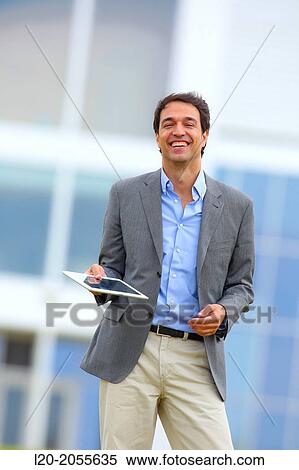 Stock Photography - Businessman with tablet in business center. San Sebastian Technology Park. Donostia. Gipuzkoa. Basque Country. Spain.. Fotosearch