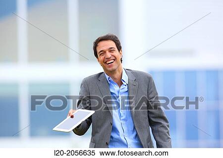 Stock Photography - Businessman with tablet in business center. San Sebastian Technology Park. Donostia. Gipuzkoa. Basque Country. Spain.. Fotosearch