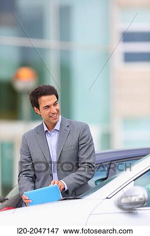 Businessman with tablet in parking business center. San Sebastian Technology Park. Donostia. Gipuzkoa. Basque Country. Spain. View Large Photo Image Stock Photo - Businessman with tablet in parking business center. San Sebastian Technology Park. Donostia. Gipuzkoa. Basque Country. Spain.. Fotosearch