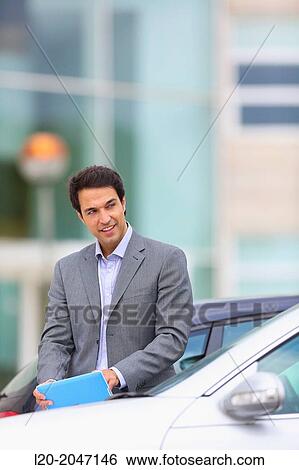 Businessman with tablet in parking business center. San Sebastian Technology Park. Donostia. Gipuzkoa. Basque Country. Spain. View Large Photo Image Stock Photograph - Businessman with tablet in parking business center. San Sebastian Technology Park. Donostia. Gipuzkoa. Basque Country. Spain.. Fotosearch