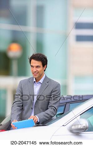 Businessman with tablet in parking business center. San Sebastian Technology Park. Donostia. Gipuzkoa. Basque Country. Spain. View Large Photo Image Stock Photography - Businessman with tablet in parking business center. San Sebastian Technology Park. Donostia. Gipuzkoa. Basque Country. Spain.. Fotosearch