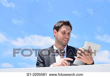 Businessman with tablet outdoors. View Large Photo Image Stock Image - Businessman with tablet outdoors.. Fotosearch