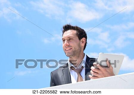 Businessman with tablet outdoors. View Large Photo Image Stock Image - Businessman with tablet outdoors.. Fotosearch