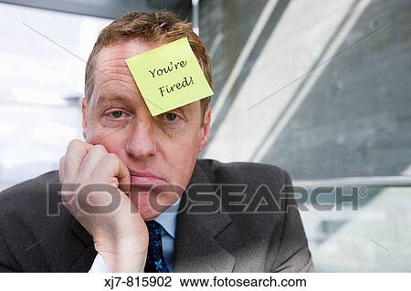 Businessman with? you? re fired? note attached to his forehead View Large Photo Image Stock Image - Businessman with? you? re fired? note attached to his forehead. Fotosearch