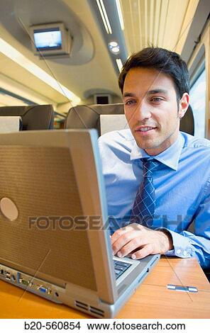 Businessman working connected to the internet. Passenger. AVE, Tren de Alta Velocidad, Zaragoza, Arag? n. Spain. View Large Photo Image Picture - Businessman working connected to the internet. Passenger. AVE, Tren de Alta Velocidad, Zaragoza, Arag? n. Spain.. Fotosearch