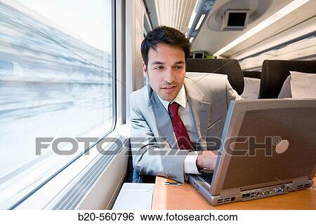 Businessman working connected to the internet. Passenger. AVE, Tren de Alta Velocidad, Zaragoza, Arag? n. Spain. View Large Photo Image Stock Photograph - Businessman working connected to the internet. Passenger. AVE, Tren de Alta Velocidad, Zaragoza, Arag? n. Spain.. Fotosearch