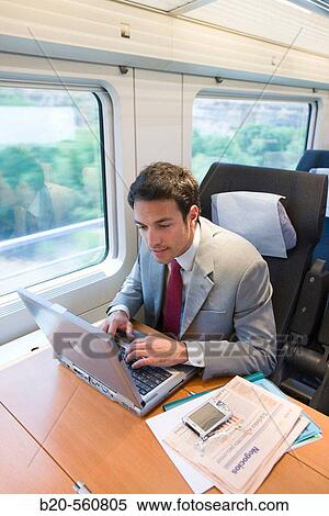 Businessman working connected to the internet. Passenger. AVE, Tren de Alta Velocidad, Zaragoza, Arag? n. Spain. View Large Photo Image Stock Photography - Businessman working connected to the internet. Passenger. AVE, Tren de Alta Velocidad, Zaragoza, Arag? n. Spain.. Fotosearch