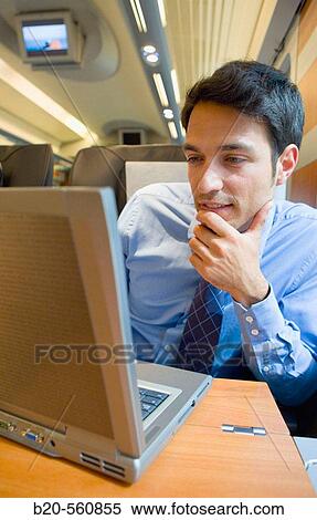 Businessman working connected to the internet. Passenger. AVE, Tren de Alta Velocidad, Zaragoza, Arag? n. Spain. View Large Photo Image Stock Photography - Businessman working connected to the internet. Passenger. AVE, Tren de Alta Velocidad, Zaragoza, Arag? n. Spain.. Fotosearch