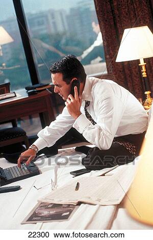 Businessman working with laptop on the bed in a hotel room View Large Photo Image Stock Image - Businessman working with laptop on the bed in a hotel room. Fotosearch