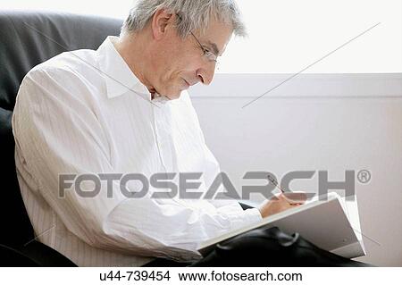 Picture - Businessman writing in his note book. Fotosearch