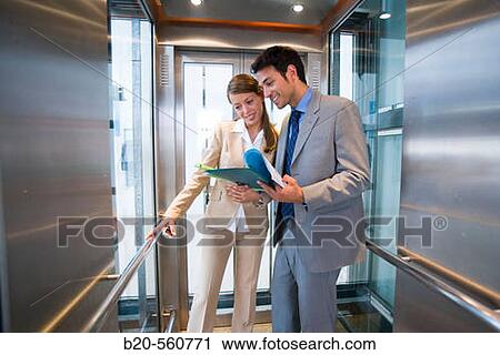 Businessmen. Elevator. Train station. Lleida, Catalua. Spain. View Large Photo Image Stock Image - Businessmen. Elevator. Train station. Lleida, Catalua. Spain.. Fotosearch