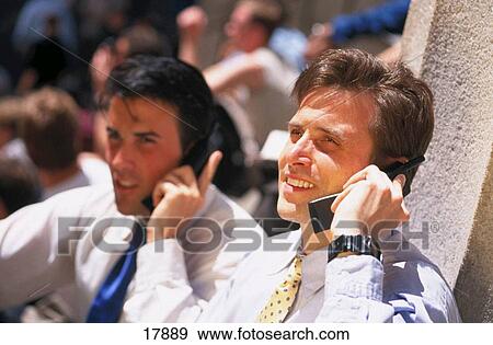 Stock Photo - Businessmen on cellular phones. Fotosearch
