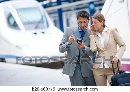 Businessmen. Passengers. AVE, Tren de Alta Velocidad. Train station. Lleida, Catalua. Spain. View Large Photo Image Stock Photo - Businessmen. Passengers. AVE, Tren de Alta Velocidad. Train station. Lleida, Catalua. Spain.. Fotosearch