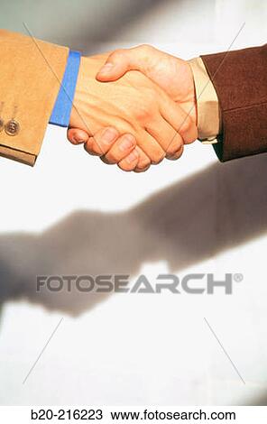 Stock Image - Businessmen shaking hands. Fotosearch