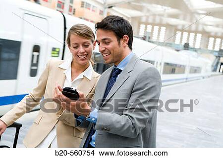 Picture - Businessmen. Travelers. AVE, Tren de Alta Velocidad. Delicias station, Zaragoza, Arag? n. Spain.. Fotosearch