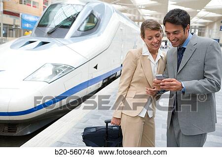 Businessmen. Travelers. AVE, Tren de Alta Velocidad. Delicias station, Zaragoza, Arag? n. Spain. View Large Photo Image Stock Photo - Businessmen. Travelers. AVE, Tren de Alta Velocidad. Delicias station, Zaragoza, Arag? n. Spain.. Fotosearch