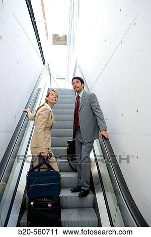 Businessmen travelling. Escalator. View Large Photo Image Stock Image - Businessmen travelling. Escalator.. Fotosearch