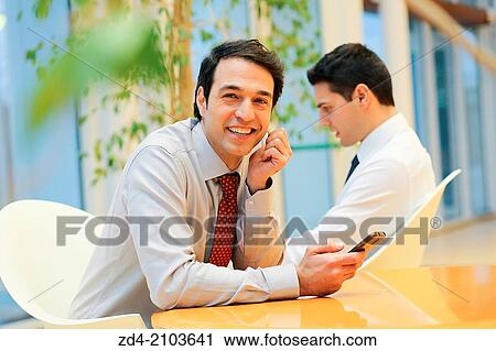 Stock Image - Businessmen using smartphones. Fotosearch