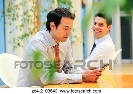 Businessmen using smartphones View Large Photo Image Stock Image - Businessmen using smartphones. Fotosearch