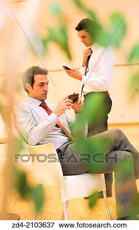Businessmen using smartphones View Large Photo Image Stock Photo - Businessmen using smartphones. Fotosearch