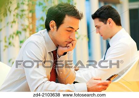Businessmen using smartphones View Large Photo Image Stock Photo - Businessmen using smartphones. Fotosearch