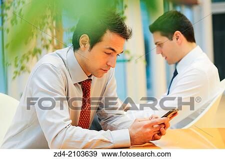 Businessmen using smartphones View Large Photo Image Stock Photo - Businessmen using smartphones. Fotosearch