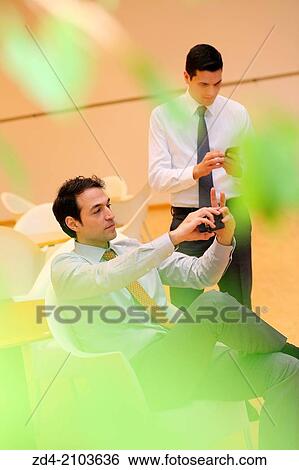 Businessmen using smartphones View Large Photo Image Stock Photograph - Businessmen using smartphones. Fotosearch