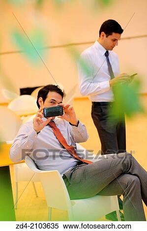 Businessmen using smartphones View Large Photo Image Stock Photography - Businessmen using smartphones. Fotosearch