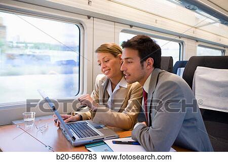 Businessmen working connected to the internet. Passenger. AVE, Tren de Alta Velocidad, Zaragoza, Arag? n. Spain. View Large Photo Image Stock Image - Businessmen working connected to the internet. Passenger. AVE, Tren de Alta Velocidad, Zaragoza, Arag? n. Spain.. Fotosearch