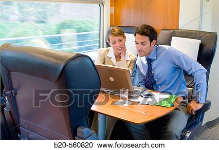 Stock Image - Businessmen working connected to the internet. Passenger. AVE, Tren de Alta Velocidad, Zaragoza, Arag? n. Spain.. Fotosearch