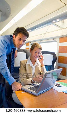Businessmen working connected to the internet. Passenger. AVE, Tren de Alta Velocidad, Zaragoza, Arag? n. Spain. View Large Photo Image Stock Image - Businessmen working connected to the internet. Passenger. AVE, Tren de Alta Velocidad, Zaragoza, Arag? n. Spain.. Fotosearch
