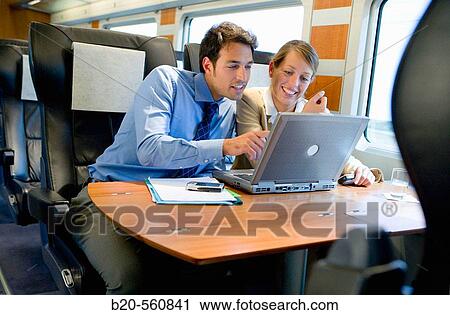 Businessmen working connected to the internet. Passenger. AVE, Tren de Alta Velocidad, Zaragoza, Arag? n. Spain. View Large Photo Image Stock Image - Businessmen working connected to the internet. Passenger. AVE, Tren de Alta Velocidad, Zaragoza, Arag? n. Spain.. Fotosearch