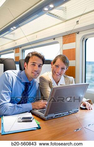 Businessmen working connected to the internet. Passenger. AVE, Tren de Alta Velocidad, Zaragoza, Arag? n. Spain. View Large Photo Image Stock Image - Businessmen working connected to the internet. Passenger. AVE, Tren de Alta Velocidad, Zaragoza, Arag? n. Spain.. Fotosearch