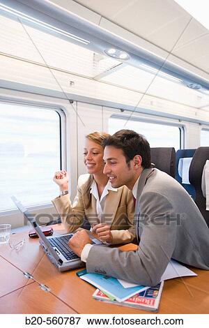 Stock Photo - Businessmen working connected to the internet. Passenger. AVE, Tren de Alta Velocidad, Zaragoza, Arag? n. Spain.. Fotosearch