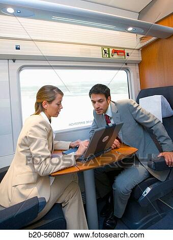 Businessmen working connected to the internet. Passenger. AVE, Tren de Alta Velocidad, Zaragoza, Arag? n. Spain. View Large Photo Image Stock Photo - Businessmen working connected to the internet. Passenger. AVE, Tren de Alta Velocidad, Zaragoza, Arag? n. Spain.. Fotosearch