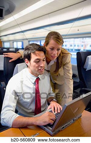Stock Photo - Businessmen working connected to the internet. Passenger. AVE, Tren de Alta Velocidad, Zaragoza, Arag? n. Spain.. Fotosearch