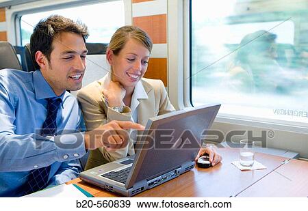 Stock Photo - Businessmen working connected to the internet. Passenger. AVE, Tren de Alta Velocidad, Zaragoza, Arag? n. Spain.. Fotosearch