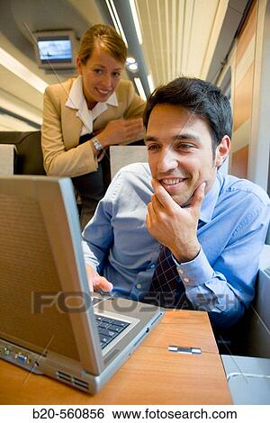Businessmen working connected to the internet. Passenger. AVE, Tren de Alta Velocidad, Zaragoza, Arag? n. Spain. View Large Photo Image Stock Photograph - Businessmen working connected to the internet. Passenger. AVE, Tren de Alta Velocidad, Zaragoza, Arag? n. Spain.. Fotosearch