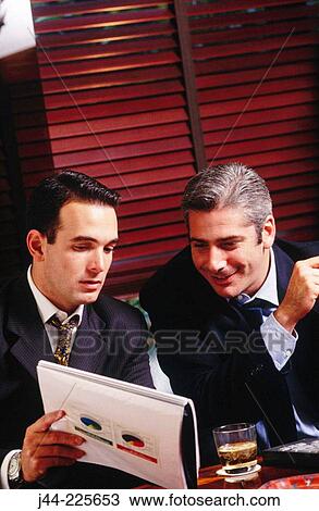 Businessmen working in a hotel lounge View Large Photo Image Stock Image - Businessmen working in a hotel lounge. Fotosearch