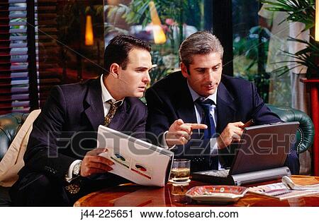 Businessmen working with laptop computer in a hotel lounge View Large Photo Image Stock Image - Businessmen working with laptop computer in a hotel lounge. Fotosearch