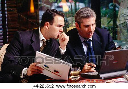 Businessmen working with laptop computer in a hotel lounge View Large Photo Image Stock Image - Businessmen working with laptop computer in a hotel lounge. Fotosearch