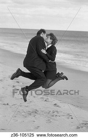 Businesspeople kissing on beach View Large Photo Image Stock Photography - Businesspeople kissing on beach. Fotosearch