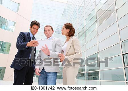 Stock Image - Businesspeople using digital tablet. Fotosearch
