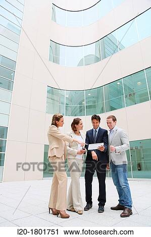 Stock Image - Businesspeople using digital tablet. Fotosearch